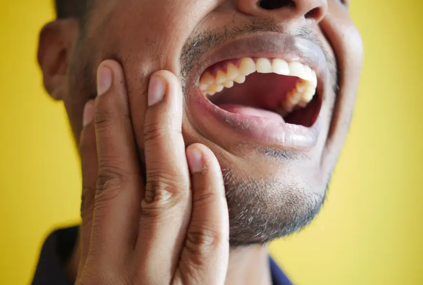 Patient experiencing tooth pain before seeing an emergency dentist in Louisville KY